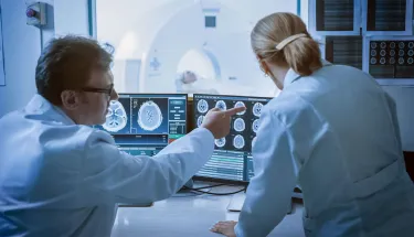 two doctors reviewing the results of a brain scan