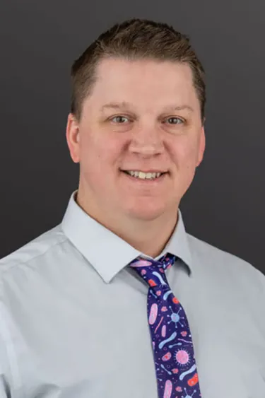 Portrait of Kevin Bonham with gray background