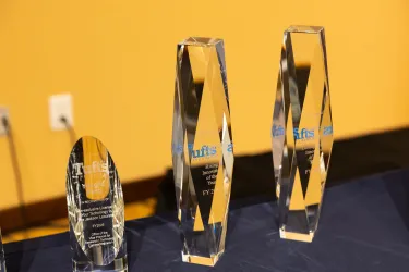 three trophy on the table with yellow background