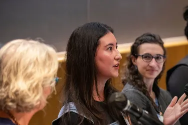 a woman in a dark top speaking as part of an entrepreneurship pane;