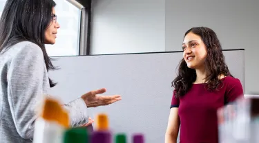 Sai Das, Scientist I on the HNRCA’s Energy Metabolism Team, and Katherine Erler, A25 in the lab