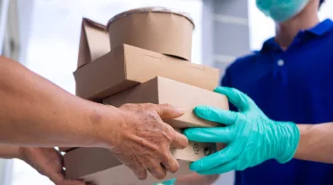 delivery person handing food boxes