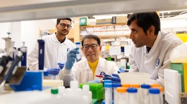 Dr. Jake Jinkun Chen, Professor of Periodontology, interacts with students in his lab