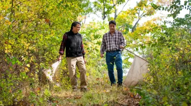  Sam R. Telford and Linden Hu walking in a forest
