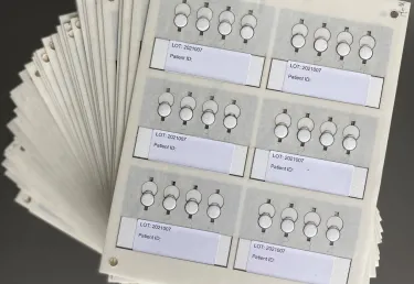 A number of paper cards with tabs for information and patient numbers. Tufts researchers collaborate with scientists in South Africa to trial a more precise medical device to measure HIV viral loads