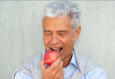 Man taking a bite out of an apple