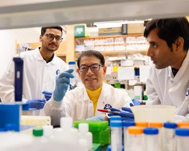 Dr. Jake Jinkun Chen, Professor of Periodontology, interacts with students in his lab