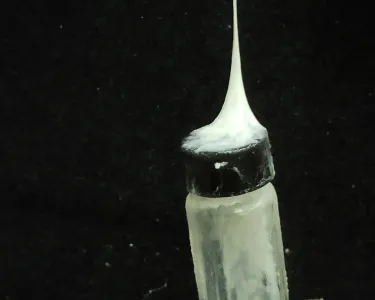 bottle picked up with web of strings