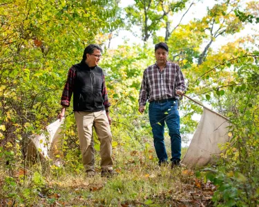  Sam R. Telford and Linden Hu walking in a forest