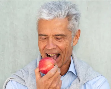 Man taking a bite out of an apple